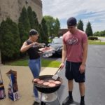 Specialty Plastic Fabricators grilling burgers at team cookout