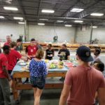 specialty plastic fabricators team eating lunch together at a team cookout