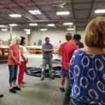 Team meeting at specialty plastic fabricators in the warehouse